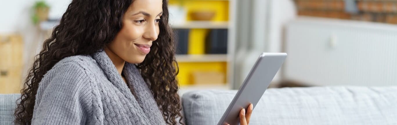 Woman wearing a sweater looking at VONVENDI® information on her tablet.