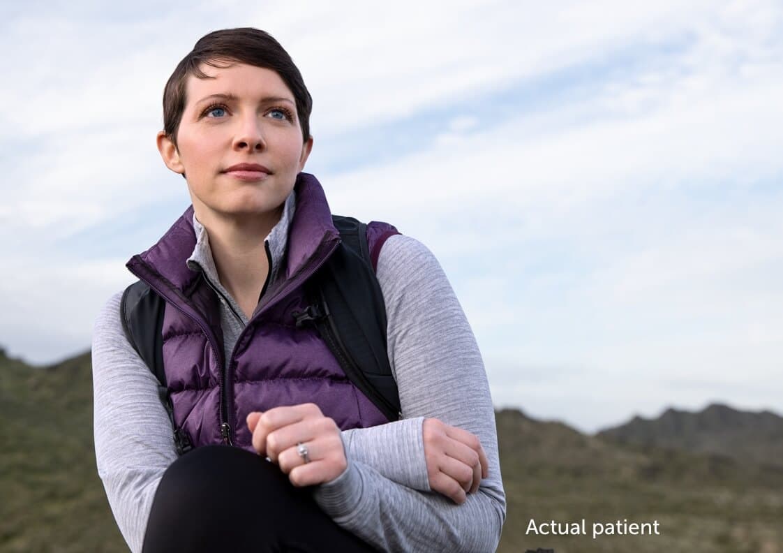 Leslie, a real VWD patient sitting down looking at the horizon.