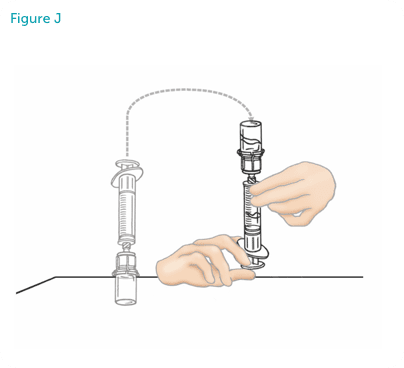 Hands flipping the vial on top of the syringe.