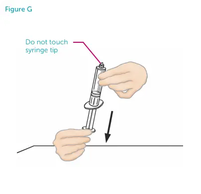 Hands pulling the empty syringe down. Do not touch syringe tip.