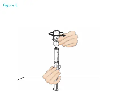 Hands disconnecting the vial from the syringe.